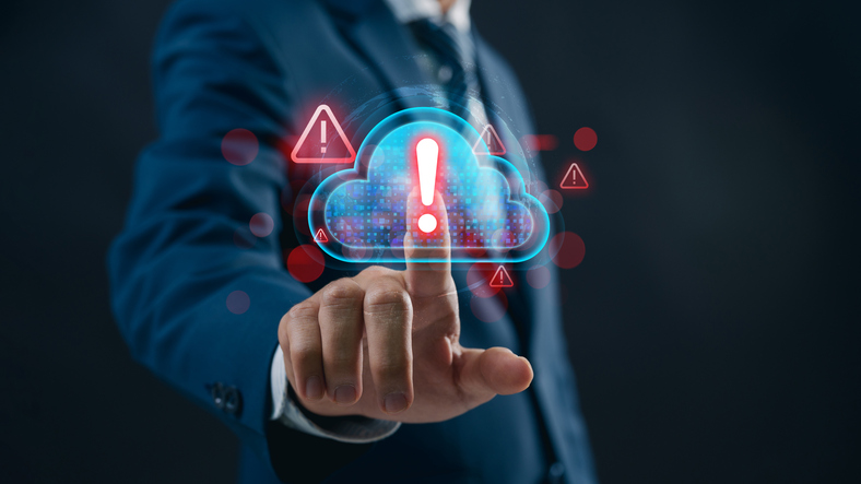 A business professional examines a cloud‑security alert on a digital dashboard, revealing overlooked compliance risks and warning indicators that highlight gaps IT teams often miss in cloud governance and data protection.
