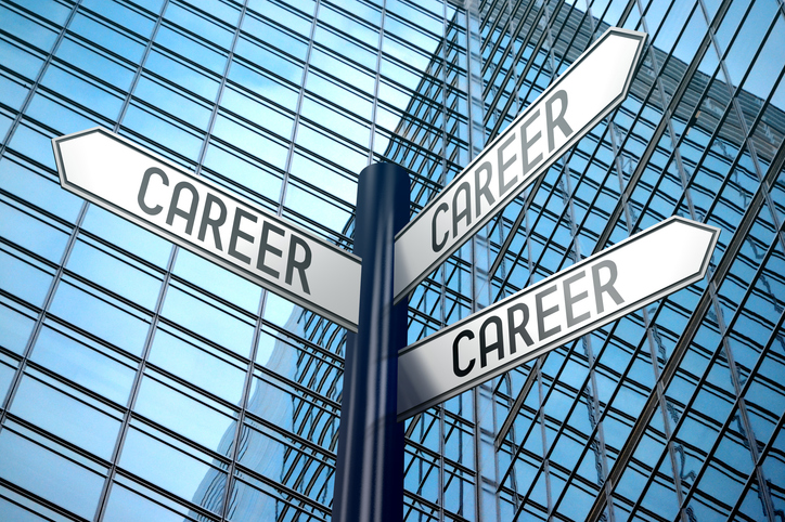 No Degree? High-Income Career Changes to Make Right Now. Career - crossroads sign, office building.
